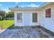 Home's exterior features a side door and windows with lush green lawns at 961 Piedmont Se Dr, Winter Haven, FL 33880