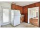 Functional kitchen with classic wood cabinetry, white refrigerator and access to the dining area at 961 Piedmont Se Dr, Winter Haven, FL 33880