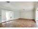 Spacious living room with tile flooring and sliding glass doors leading to the backyard at 961 Piedmont Se Dr, Winter Haven, FL 33880