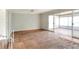 Open living space with tile floors and sliding doors to a sunroom, offering great natural light at 961 Piedmont Se Dr, Winter Haven, FL 33880