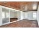 Bright sunroom features wood ceiling, tile floors, and sliding glass doors to additional space at 961 Piedmont Se Dr, Winter Haven, FL 33880