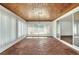 Spacious sunroom boasts wood ceilings, tile floors, and walls of windows overlooking the property at 961 Piedmont Se Dr, Winter Haven, FL 33880