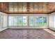 Bright sunroom with walls of windows offering plenty of natural light and backyard views at 961 Piedmont Se Dr, Winter Haven, FL 33880