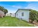 Backyard showing the house, storage shed, and pool with screened enclosure at 109 Dakota Ave, St Cloud, FL 34769