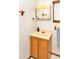 Bathroom featuring a vanity with wood cabinets, an off-white countertop, and a mirrored medicine cabinet at 109 Dakota Ave, St Cloud, FL 34769