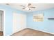 This bedroom has light blue walls, a ceiling fan, and a large closet at 109 Dakota Ave, St Cloud, FL 34769