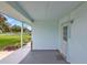 Covered front porch with concrete flooring, white pillar, and light blue walls at 109 Dakota Ave, St Cloud, FL 34769