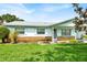 Charming single-story home featuring a well-maintained lawn and colorful landscaping at 109 Dakota Ave, St Cloud, FL 34769
