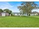 Single-story home boasting a well-kept lawn and mature tree in the front yard at 109 Dakota Ave, St Cloud, FL 34769