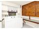 This laundry room features built-in cabinets, a window with a coffee-themed valance, and includes a washer and dryer at 109 Dakota Ave, St Cloud, FL 34769