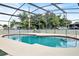 A screened pool with a small slide is surrounded by concrete and a fence at 109 Dakota Ave, St Cloud, FL 34769