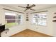 Corner sunroom overlooking backyard pool, ceiling fan, and built-in shelving at 109 Dakota Ave, St Cloud, FL 34769