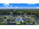 Aerial view of home featuring a screened-in pool and neighborhood at 114 Belmont Dr, Winter Haven, FL 33884