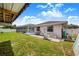 Well-kept backyard featuring a screened-in pool, lush lawn, and concrete patio at 114 Belmont Dr, Winter Haven, FL 33884