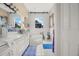 Bright bathroom featuring a double vanity, soaking tub, and charming barn door window covers at 114 Belmont Dr, Winter Haven, FL 33884