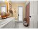 Well-lit bathroom with a white vanity, decorative accents, and a shower with a patterned curtain at 114 Belmont Dr, Winter Haven, FL 33884