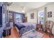 Cozy bedroom with hardwood floors, soft lighting, and charming decor for a relaxing atmosphere at 114 Belmont Dr, Winter Haven, FL 33884