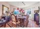 Elegant dining room with a large painting, hardwood floors, and red pendant lighting at 114 Belmont Dr, Winter Haven, FL 33884