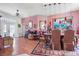 Formal dining room featuring a decorative rug, artwork, and modern red pendant lighting at 114 Belmont Dr, Winter Haven, FL 33884