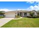 Charming single-story home with a two-car garage, stone accents, and a well-maintained lawn at 114 Belmont Dr, Winter Haven, FL 33884