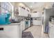 This kitchen has white cabinets, stainless steel appliances, and updated backsplash at 114 Belmont Dr, Winter Haven, FL 33884