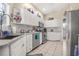 Well-lit kitchen boasts white cabinetry, stainless steel appliances, and modern backsplash at 114 Belmont Dr, Winter Haven, FL 33884