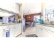 Open kitchen with a view to the dining area and living room, featuring white cabinets at 114 Belmont Dr, Winter Haven, FL 33884