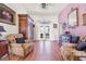 Bright living room with french doors to the back, wood floors, and comfortable furnishings at 114 Belmont Dr, Winter Haven, FL 33884