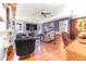 Bright living room features a ceiling fan, large TV, hardwood floors, and a comfortable seating area at 114 Belmont Dr, Winter Haven, FL 33884