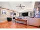 Spacious living room with hardwood floors, large TV, and a decorative fireplace at 114 Belmont Dr, Winter Haven, FL 33884