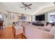 Inviting living room featuring a large TV, comfortable sofa, and hardwood flooring at 114 Belmont Dr, Winter Haven, FL 33884