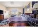 Bright main bedroom showcasing hardwood floors, a stylish rug, and tasteful decor at 114 Belmont Dr, Winter Haven, FL 33884