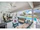 Relaxing covered patio with comfortable seating and dining, overlooking the pristine pool area at 114 Belmont Dr, Winter Haven, FL 33884