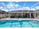 Spacious screened-in pool area with ample seating, ideal for outdoor relaxation and entertaining at 114 Belmont Dr, Winter Haven, FL 33884