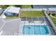 Aerial view of a screened-in pool and patio with outdoor seating at 114 Belmont Dr, Winter Haven, FL 33884