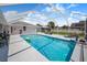 Inviting screened-in pool area with lounge chairs and a clear view of the backyard at 114 Belmont Dr, Winter Haven, FL 33884