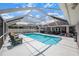 Large screened-in pool and patio with lounge area perfect for enjoying the outdoors at 114 Belmont Dr, Winter Haven, FL 33884