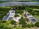 Large agricultural property featuring several greenhouses, lake views, and mature trees at 1256 Center St, Lake Wales, FL 33859