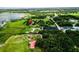 An aerial view of a community location with a lake, greenery and various buildings at 1256 Center St, Lake Wales, FL 33859