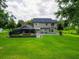 Lush backyard featuring a screened-in pool and an expansive lawn with mature trees at 1256 Center St, Lake Wales, FL 33859