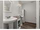 Bright bathroom featuring dual sinks, white cabinets, and a shower at 1256 Center St, Lake Wales, FL 33859