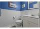 Charming half bathroom with beadboard accents, featuring a toilet, sink, and mirror at 1256 Center St, Lake Wales, FL 33859