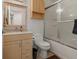 Bright bathroom featuring a shower-tub combo, vanity, and a matching wall cabinet at 1256 Center St, Lake Wales, FL 33859