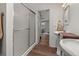 Bright bathroom featuring dual sinks, a shower, and access to a bedroom at 1256 Center St, Lake Wales, FL 33859
