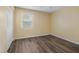 Bedroom featuring wood flooring, a window, and a closet at 1256 Center St, Lake Wales, FL 33859
