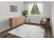 Bright bedroom with hardwood flooring, featuring a dresser, chair, and natural light at 1256 Center St, Lake Wales, FL 33859