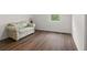 Bright bedroom featuring hardwood floors, a floral sofa, and a sunny window at 1256 Center St, Lake Wales, FL 33859