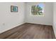 Bright bedroom with hardwood flooring, a large window, and ample natural light at 1256 Center St, Lake Wales, FL 33859
