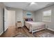 Bedroom with a queen bed, ceiling fan, side table, and an open door at 1256 Center St, Lake Wales, FL 33859