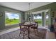 Bright dining room with large windows offering serene outdoor views, a stylish chandelier, and comfortable seating for a lovely ambiance at 1256 Center St, Lake Wales, FL 33859